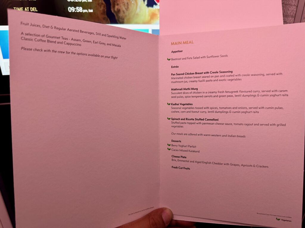 a hand holding a pink menu