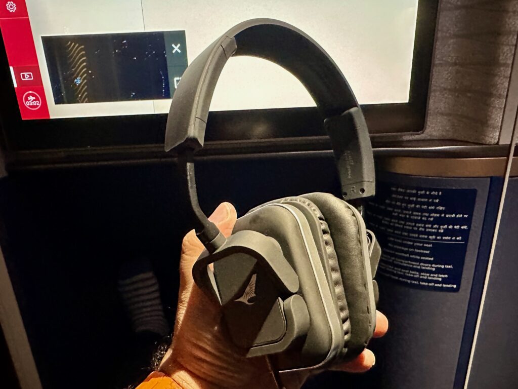 a hand holding headphones