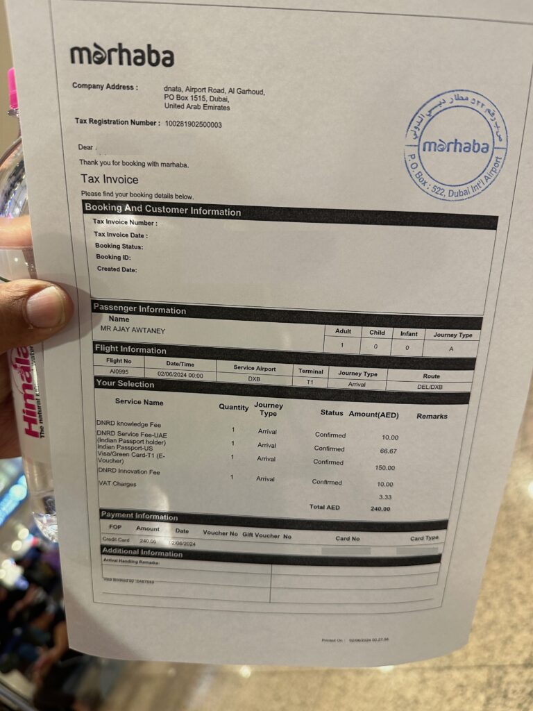 a hand holding a paper with text and numbers