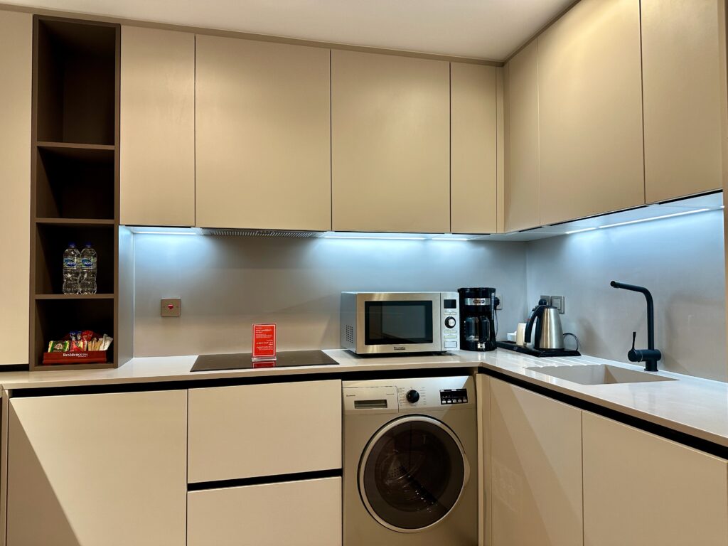 a kitchen with white cabinets and a microwave oven