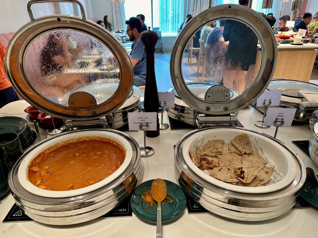 food in a buffet with a couple of plates of food