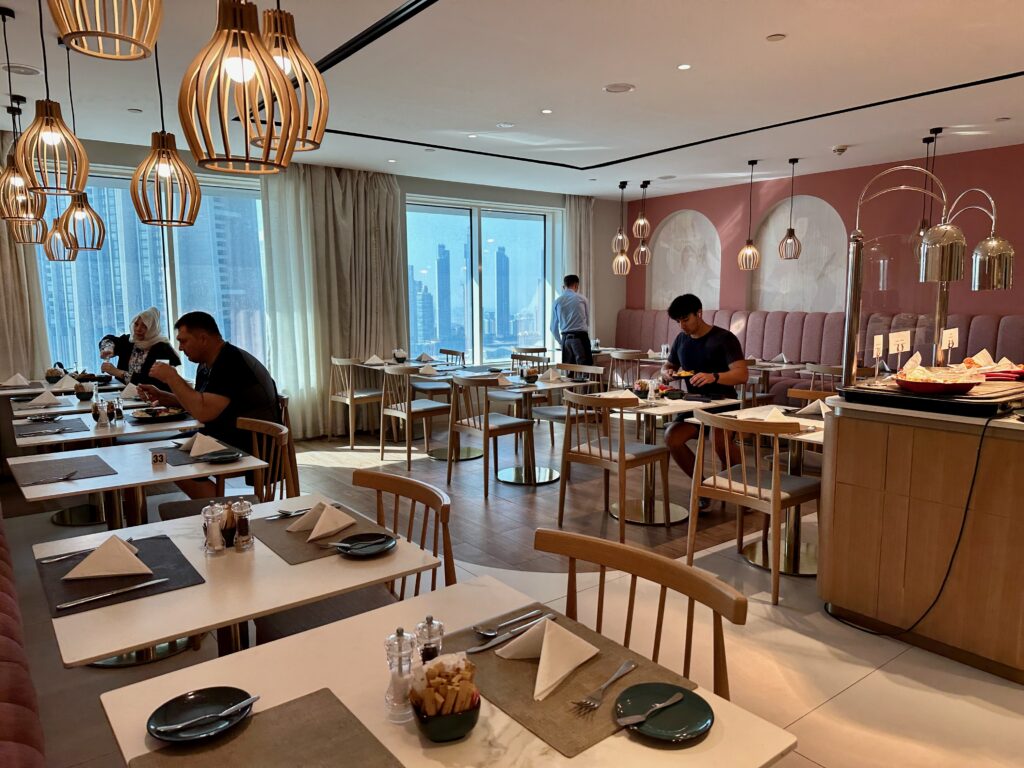 a group of people sitting at tables in a restaurant