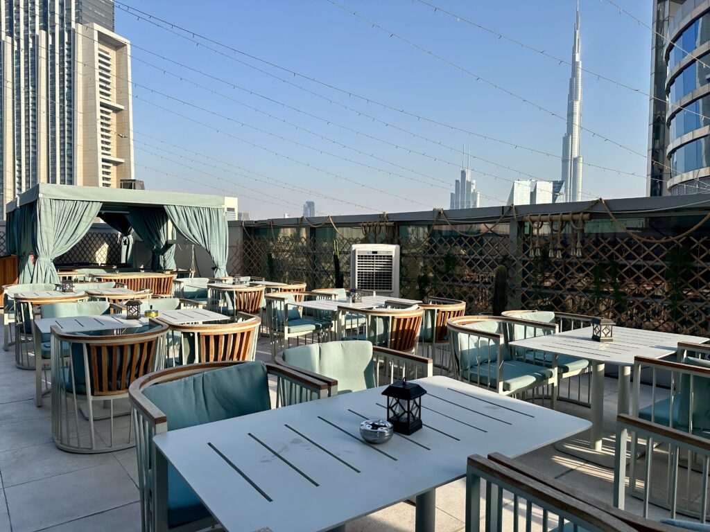 a rooftop patio with tables and chairs