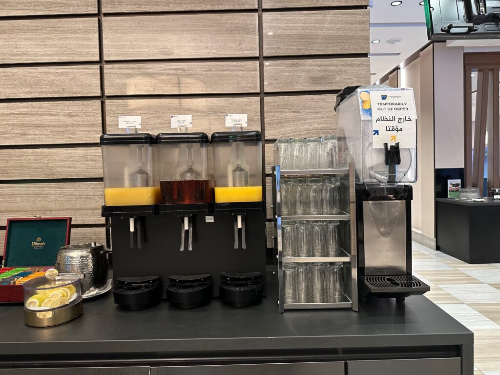 a group of juice dispensers on a counter