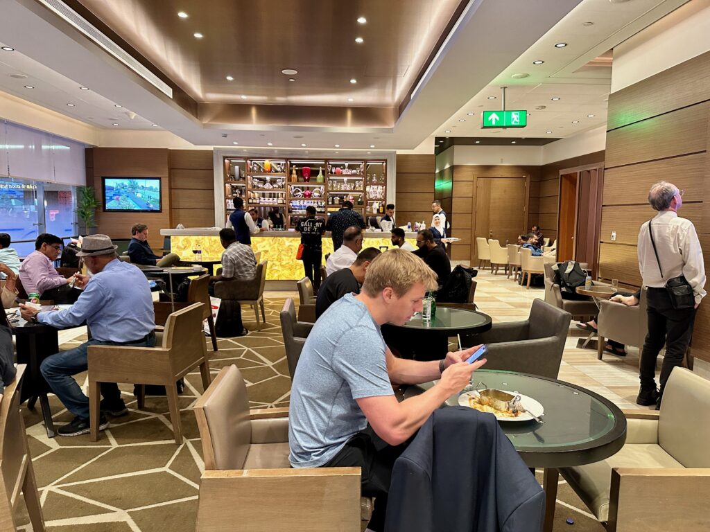 a group of people sitting at tables in a restaurant