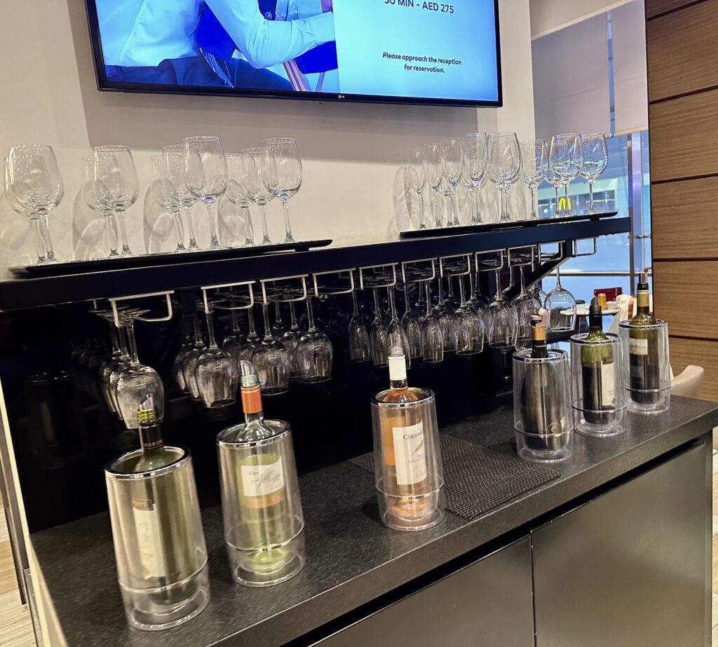 a bar with wine glasses and bottles