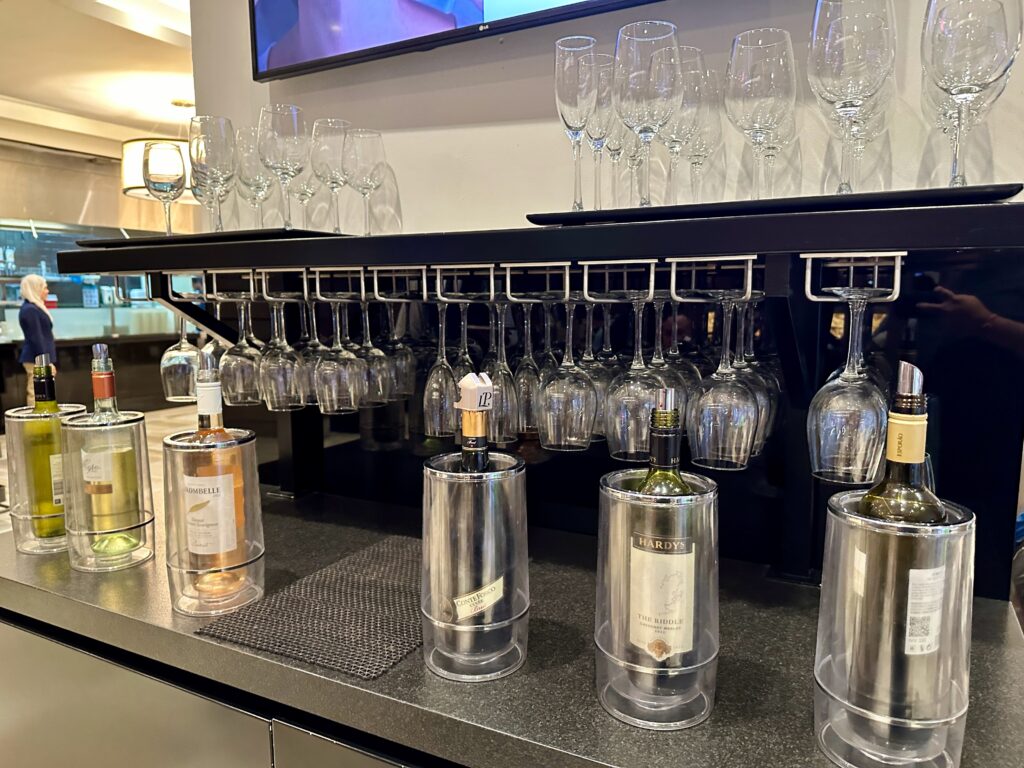 a bar with wine glasses and bottles