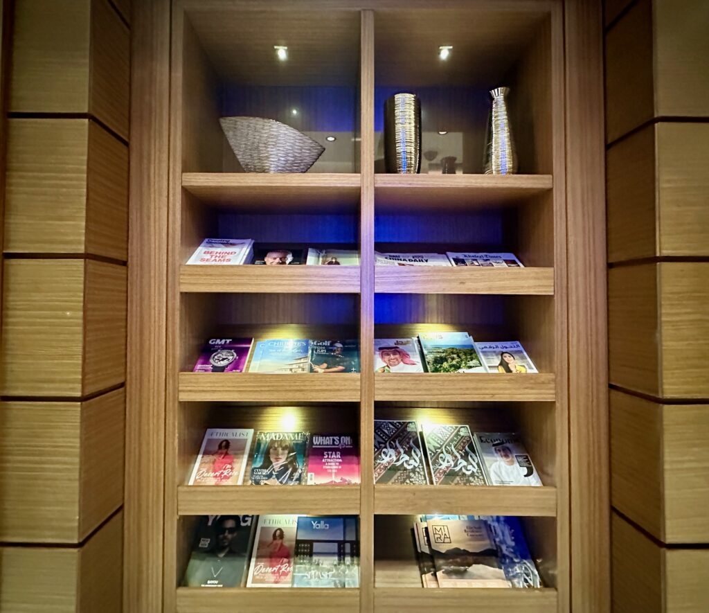 a shelf with books and vases on it