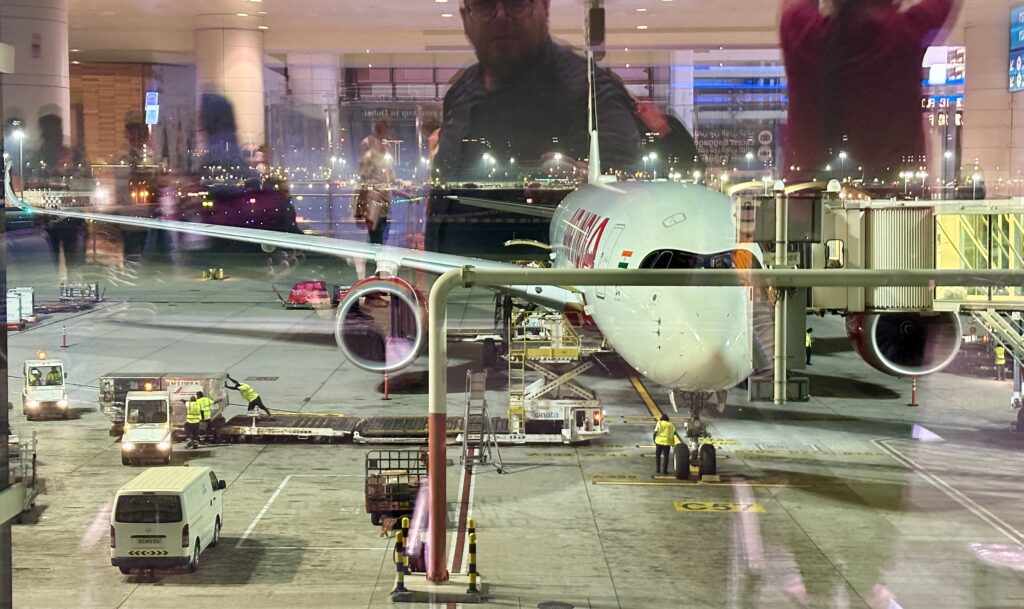 a man standing behind an airplane