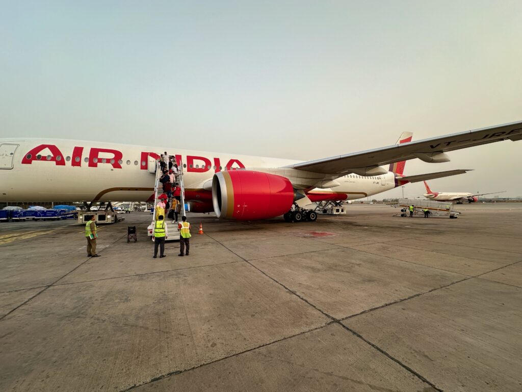 a group of people standing next to a large airplane