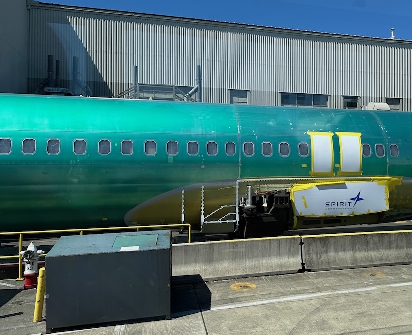 a green airplane in a hangar