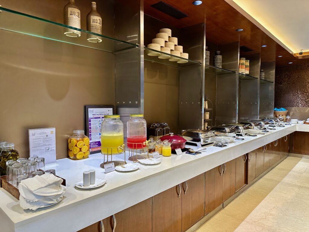 a buffet with glass shelves and food on the counter