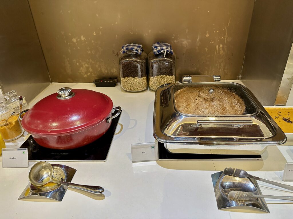 a kitchen counter with a red pan and a red lid