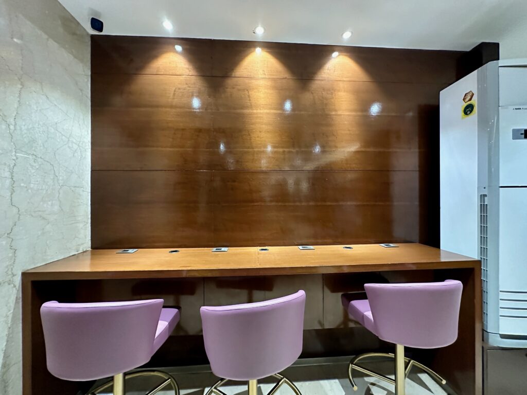 a table with purple chairs and a white door