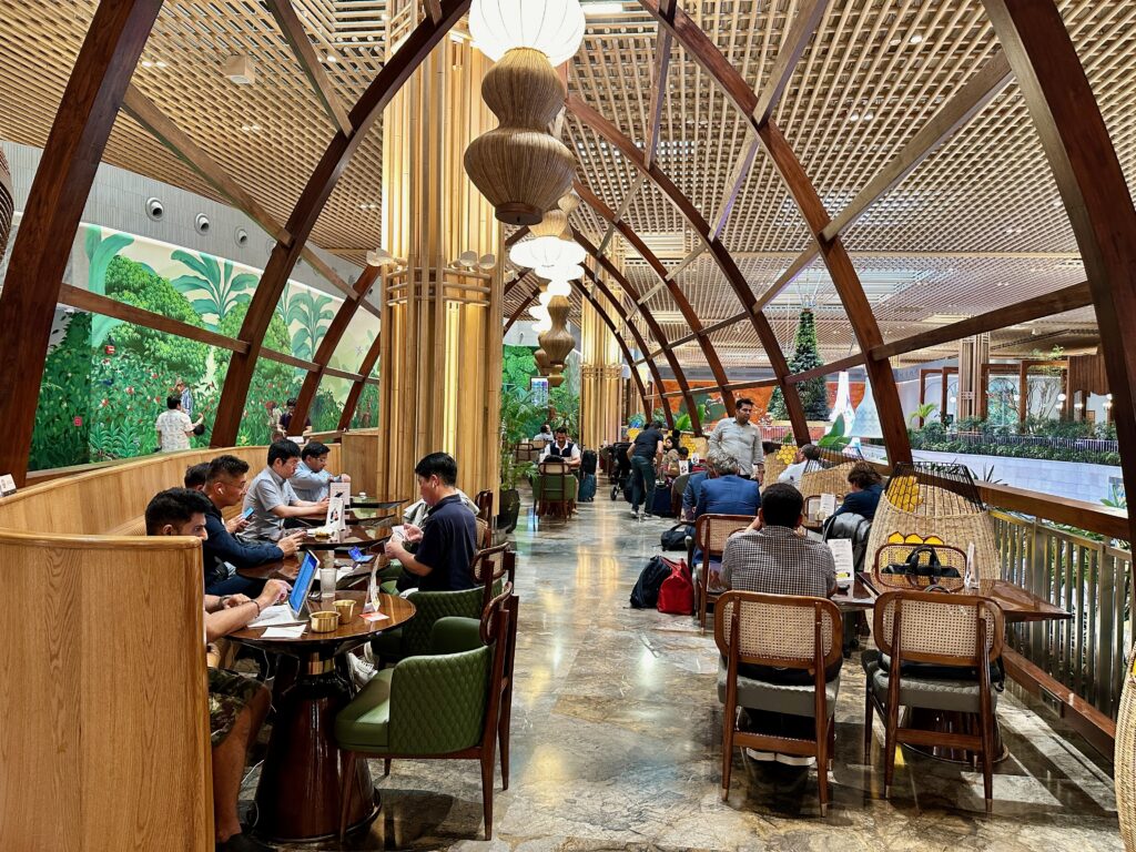 a group of people sitting at tables in a restaurant