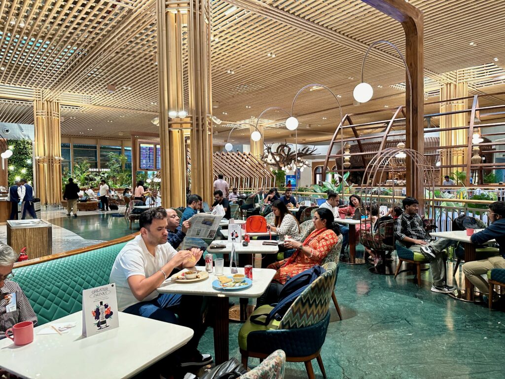 a group of people sitting at tables in a restaurant