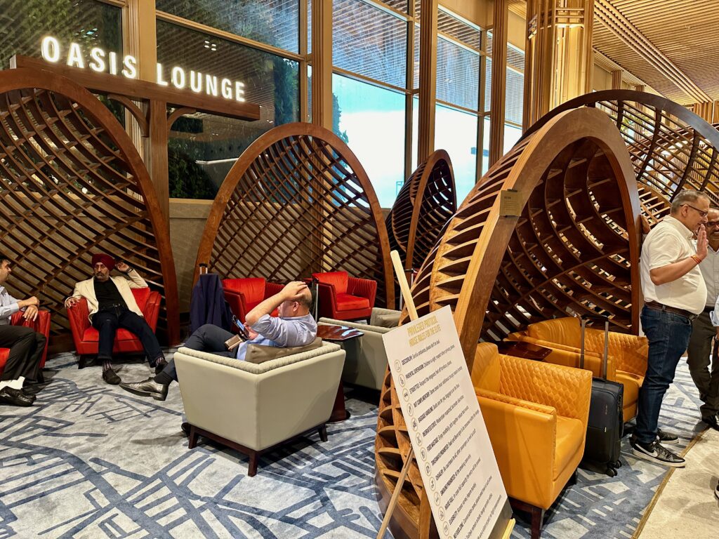 a group of people sitting in chairs in a lobby