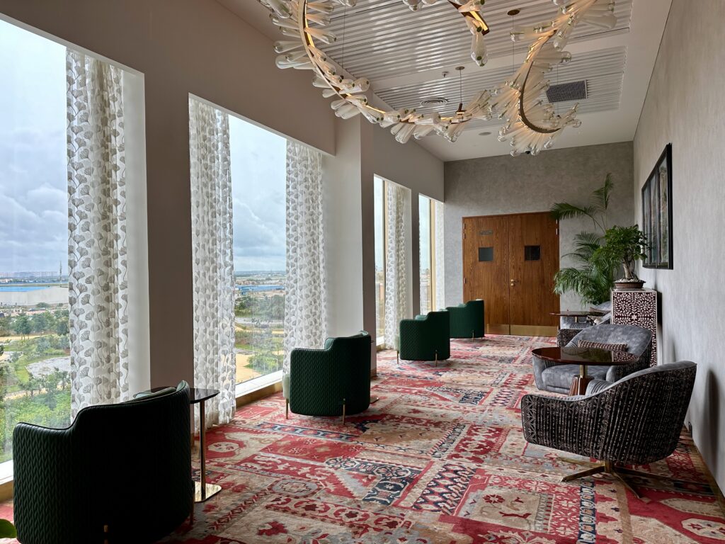 a room with a large chandelier and chairs