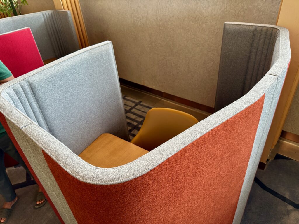 a chair and a desk in a cubicle