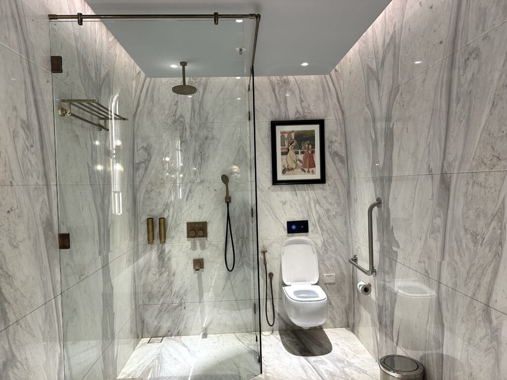 a bathroom with a glass shower and toilet