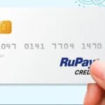 a hand holding a credit card