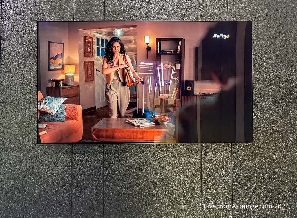 a woman playing a violin in a living room