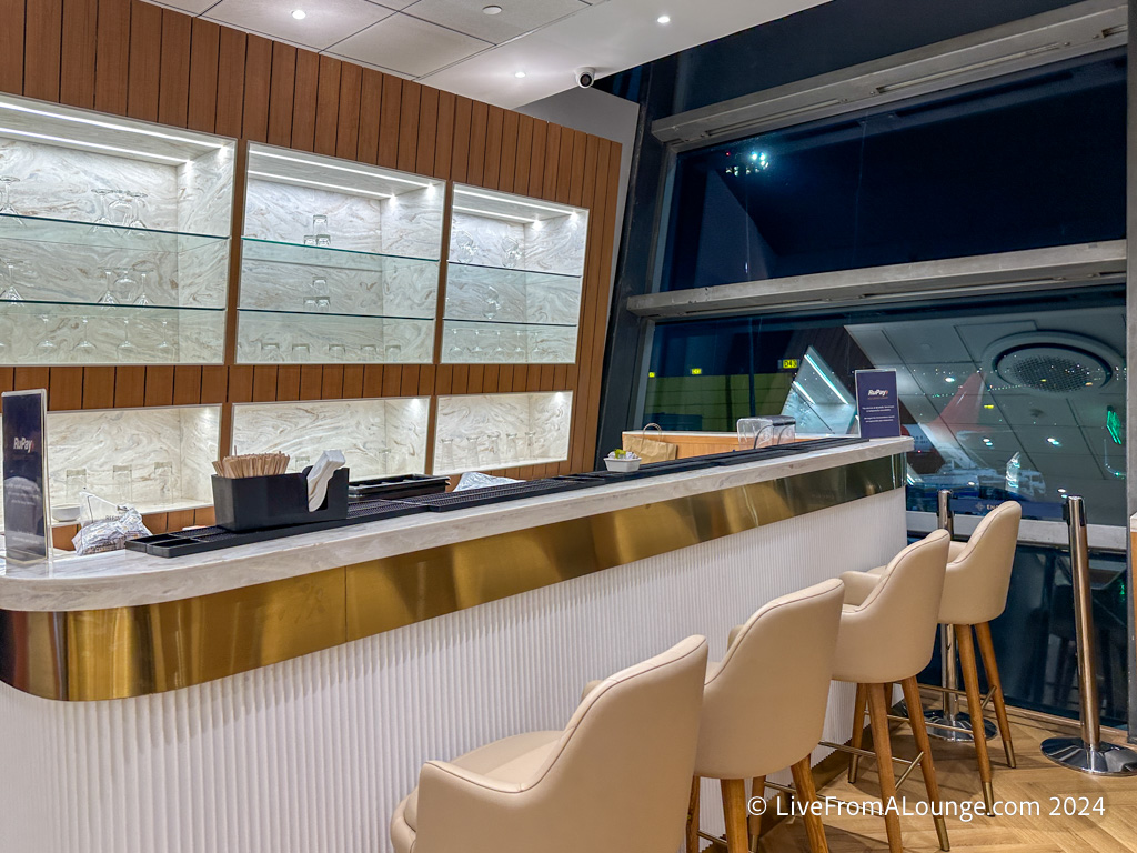 a bar with chairs and a window