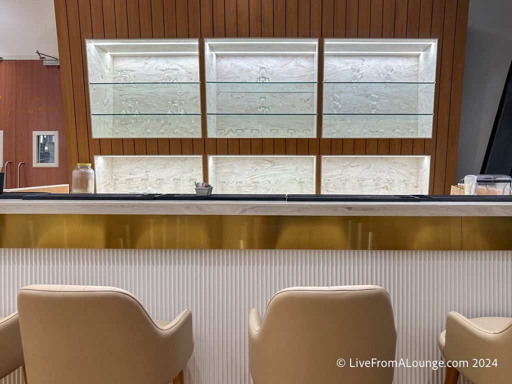 a bar with chairs and shelves