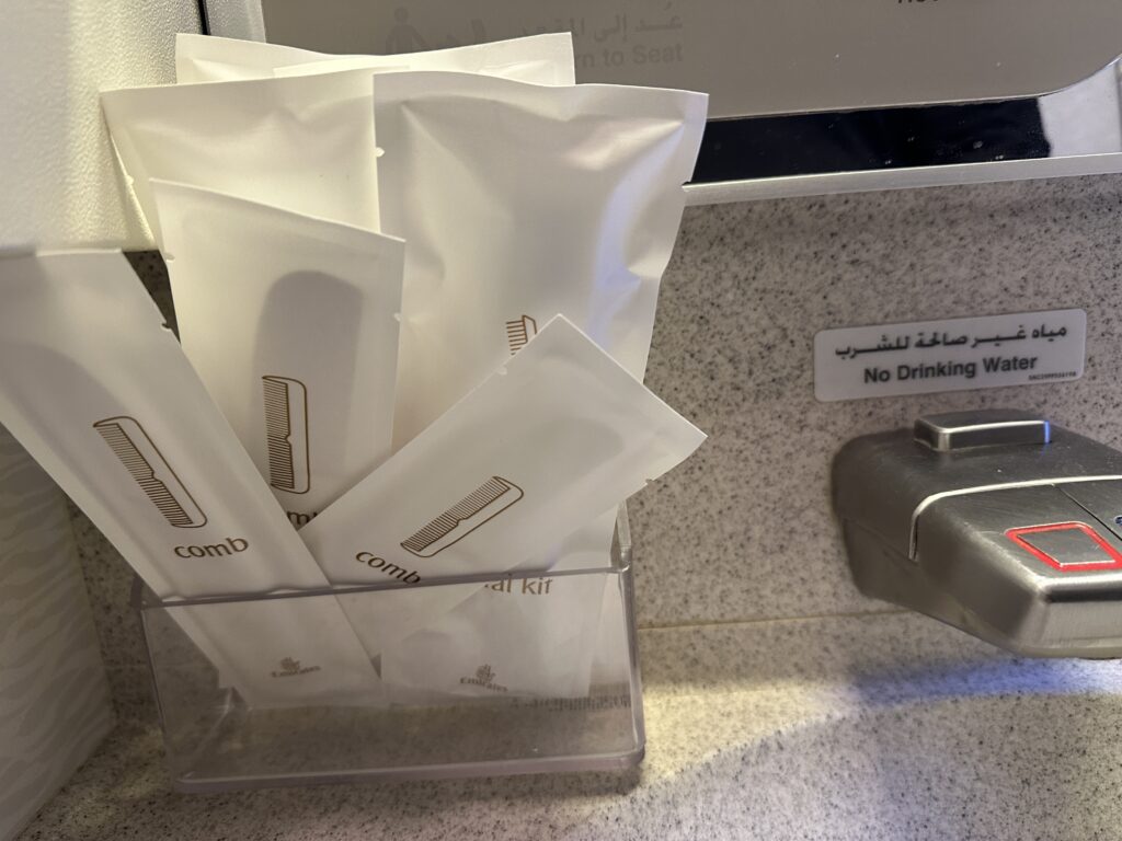 a group of white packets in a clear container next to a sink