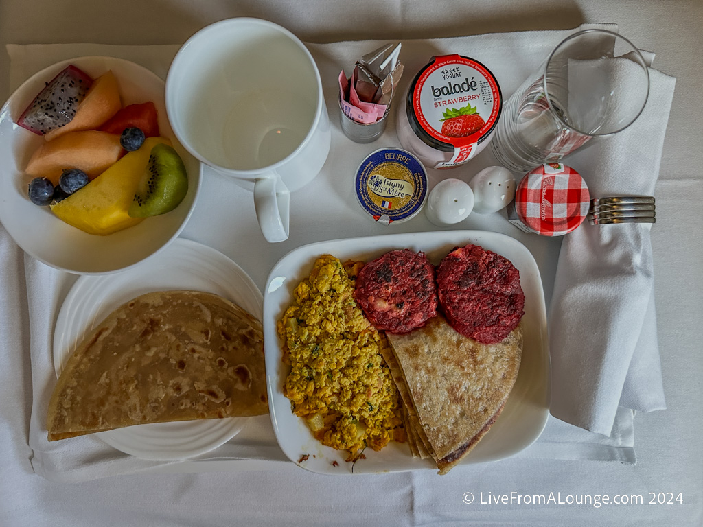 a breakfast tray with food and drinks