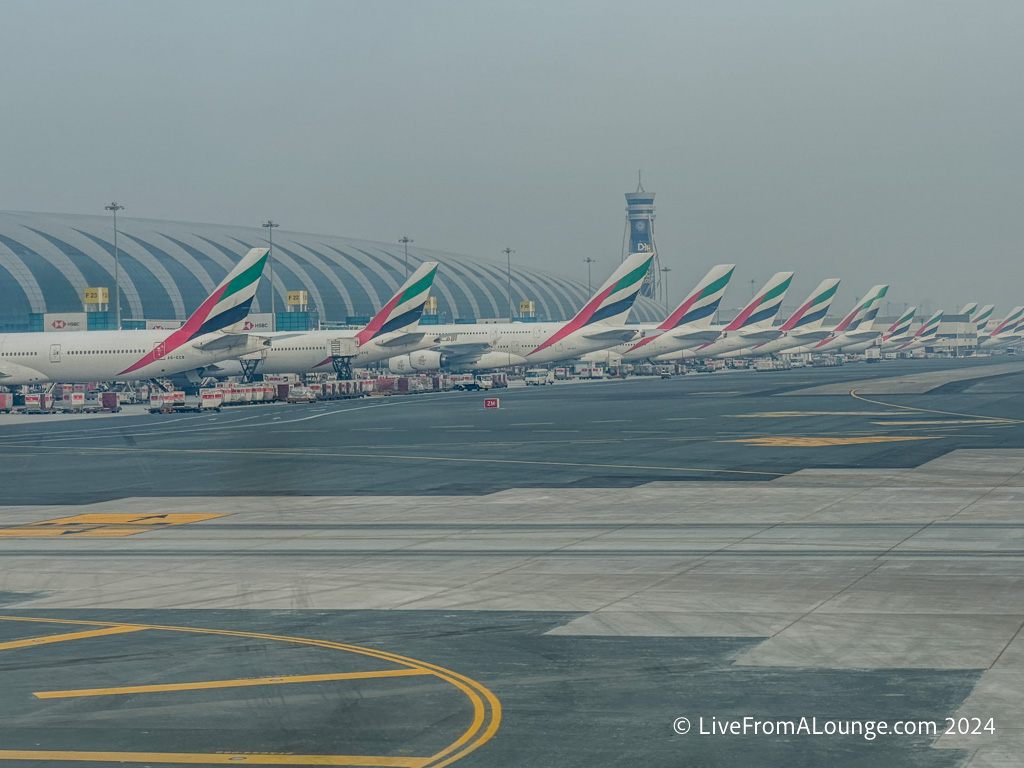 a row of airplanes parked on a runway