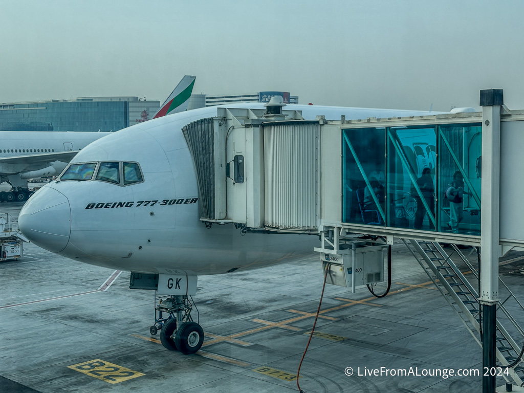 a jet plane with passengers boarding