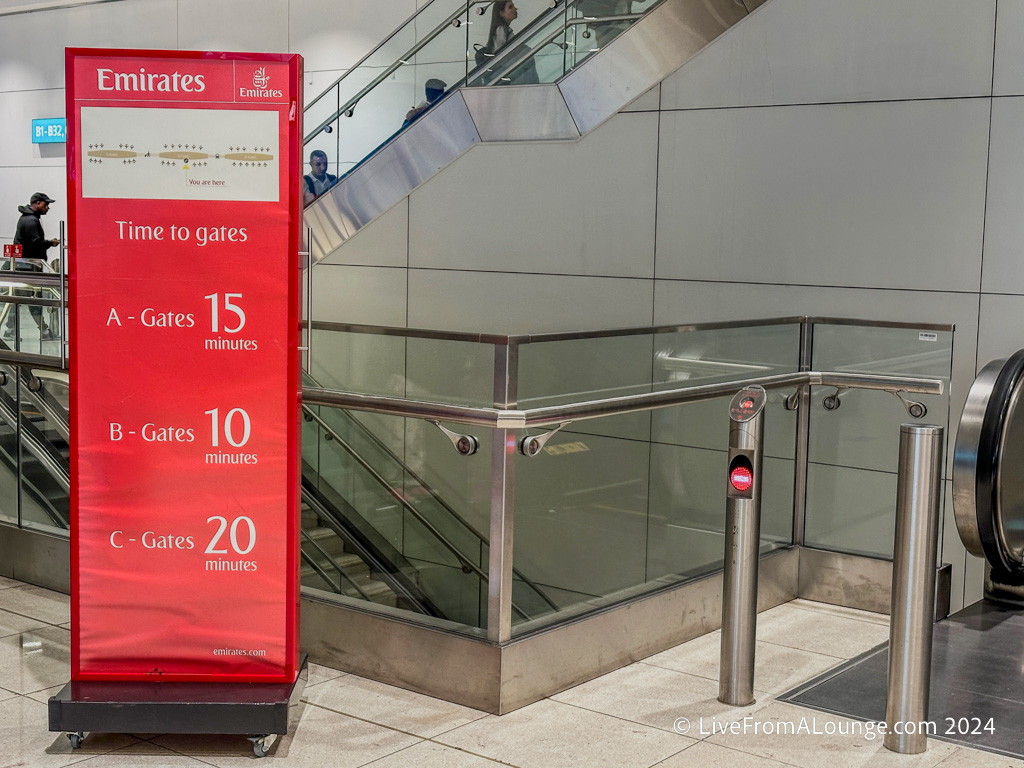 a red sign next to a glass railing