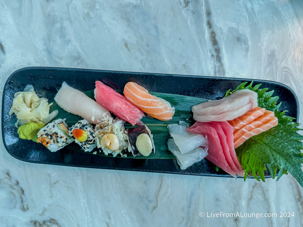 a plate of sushi on a marble surface