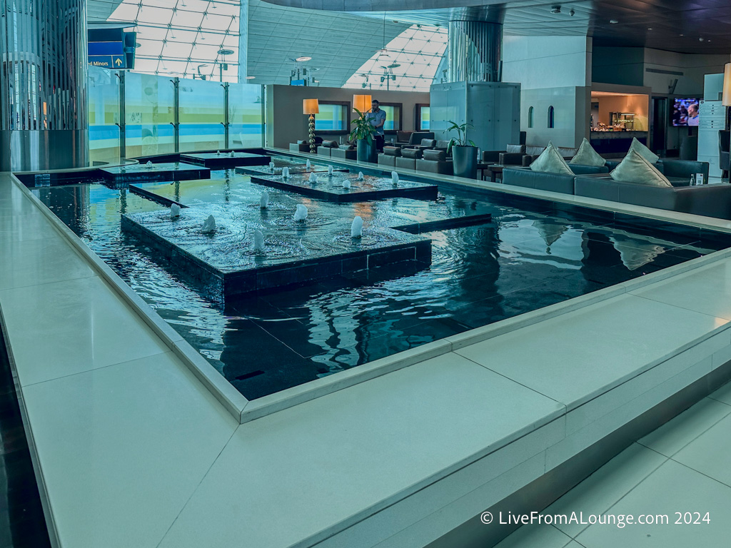 a large indoor fountain with water in a building