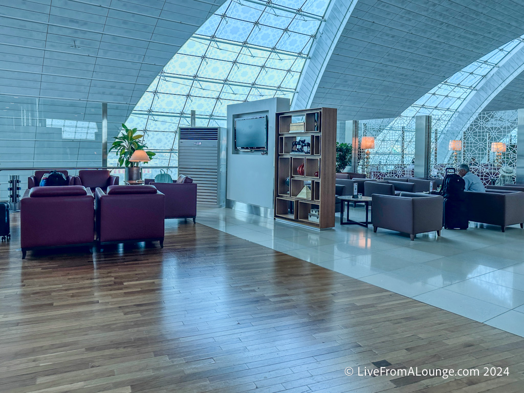 a lounge area with purple furniture and a tv