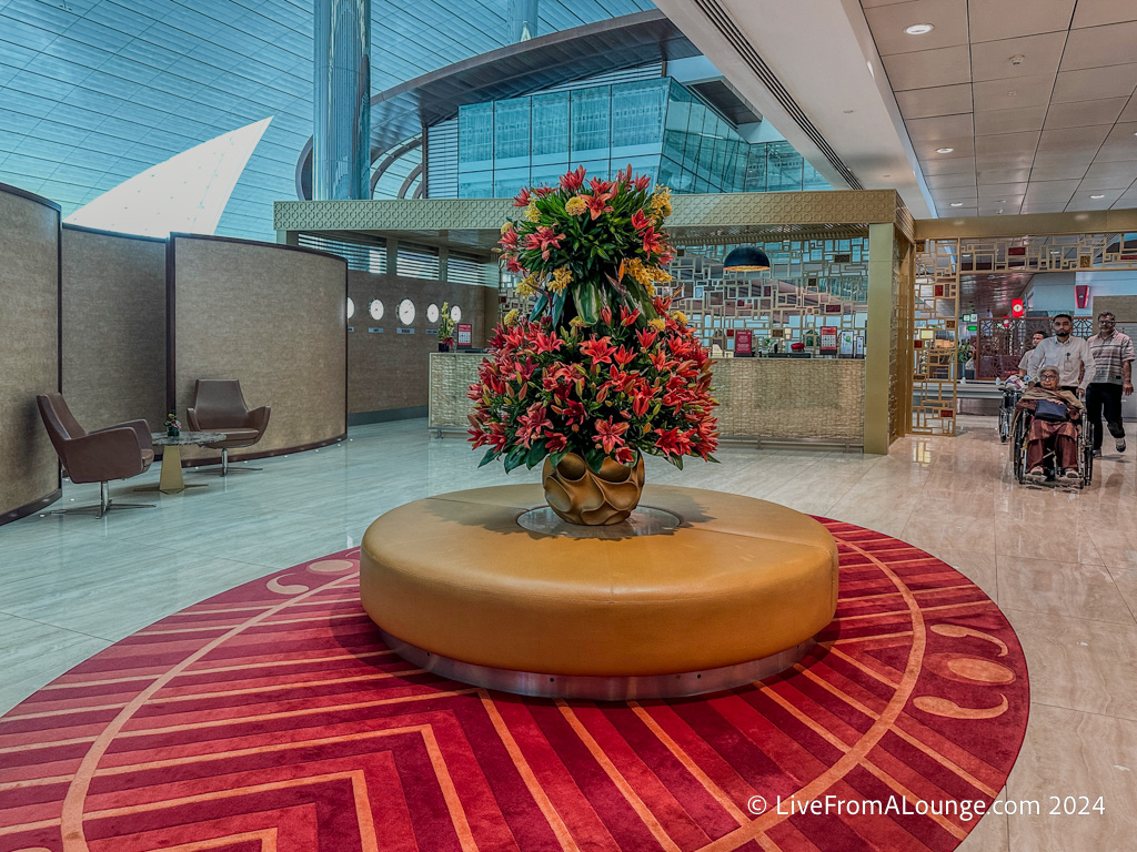 a plant on a round platform in a lobby