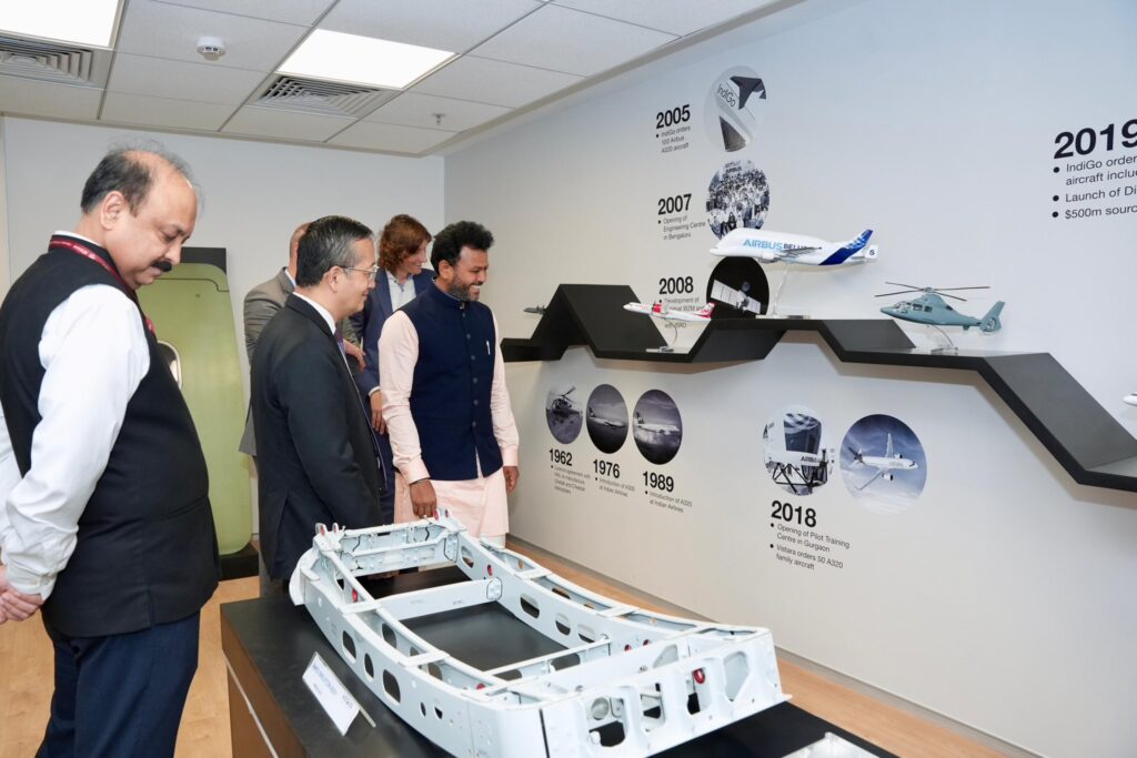 a group of people looking at a model of a plane