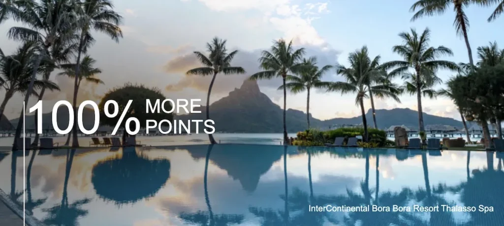 a pool with palm trees and mountains in the background