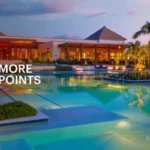 a pool with palm trees and a building