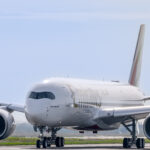 a large white airplane on a runway