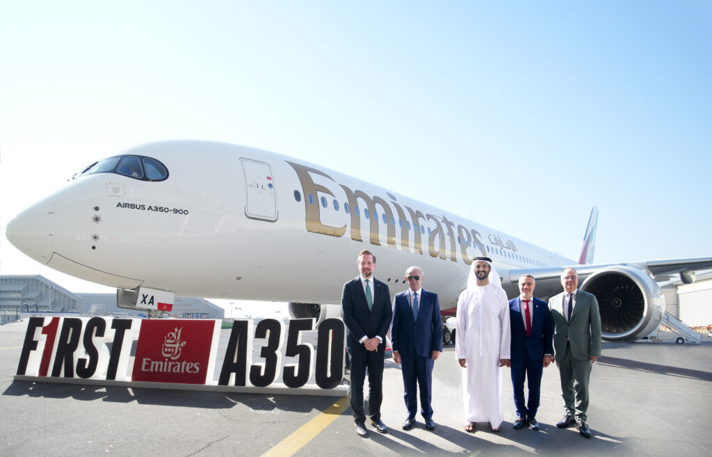 a group of men standing in front of a plane