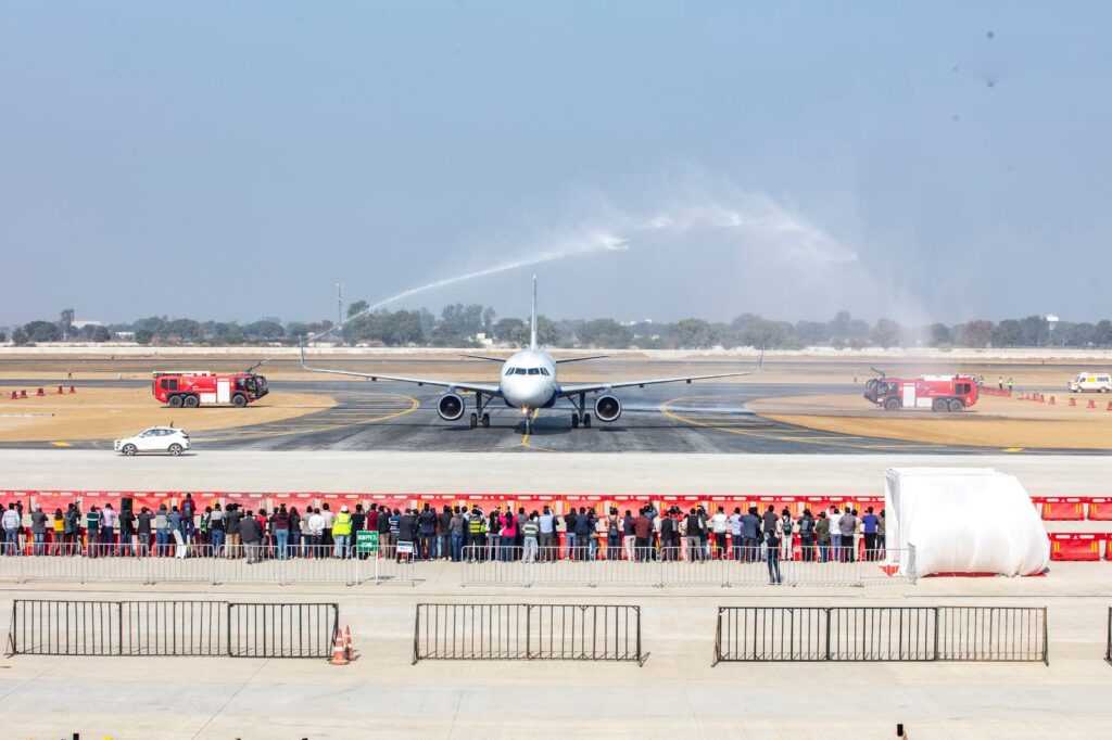 a group of people standing in front of a jet plane