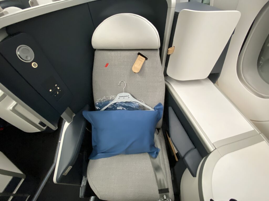 a seat with a pillow and a bag on it