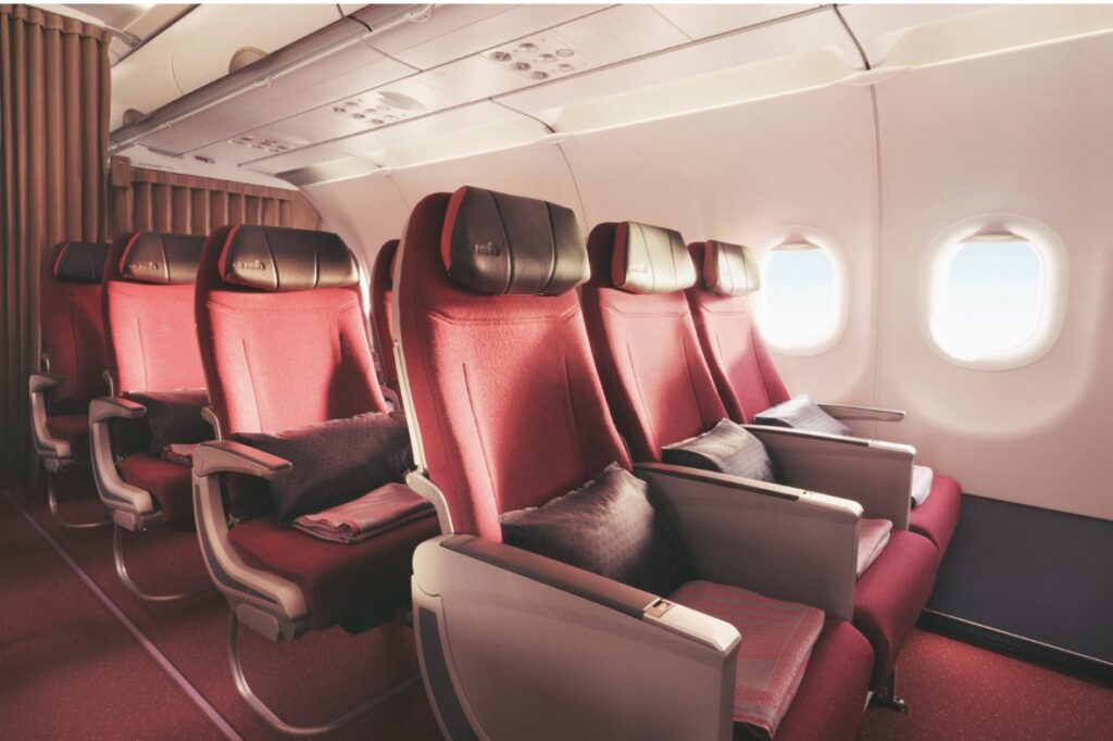 a row of red seats in an airplane