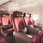 a row of red seats in an airplane