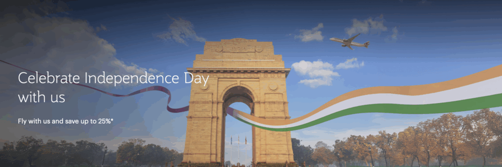 The image features the India Gate monument with a clear blue sky and a few clouds. An airplane is flying above, and a ribbon in the colors of the Indian flag (orange, white, and green) is flowing across the image. Text on the left reads "Celebrate Independence Day with us" and "Fly with us and save up to 25%*". Trees with autumn foliage are visible in the background.