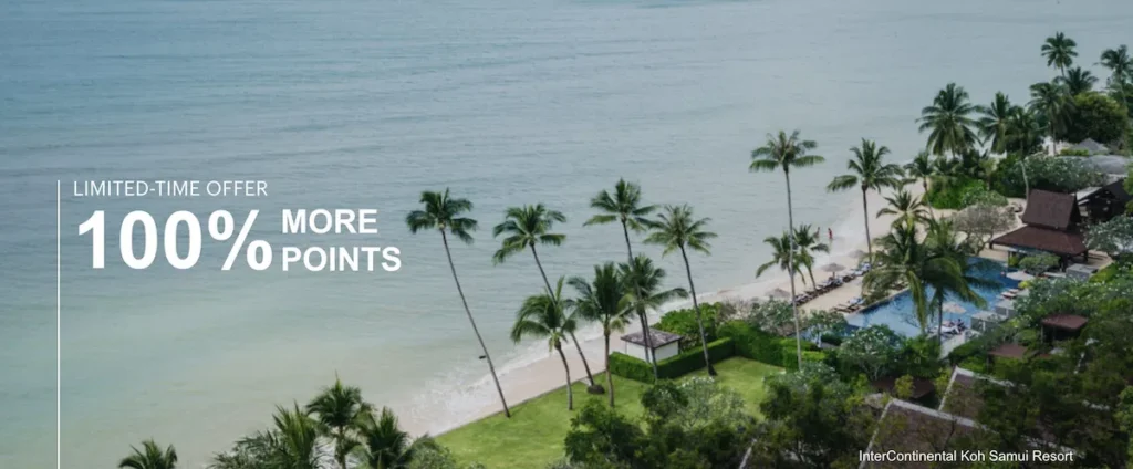 Aerial view of a tropical beach with clear blue water and a sandy shore lined with palm trees. There is a resort with a pool and several buildings surrounded by lush greenery. Text on the image reads "Limited-Time Offer 100% More Points." The bottom right corner mentions "InterContinental Koh Samui Resort."