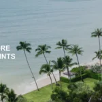 Aerial view of a tropical beach with clear blue water and a sandy shore lined with palm trees. There is a resort with a pool and several buildings surrounded by lush greenery. Text on the image reads "Limited-Time Offer 100% More Points." The bottom right corner mentions "InterContinental Koh Samui Resort."