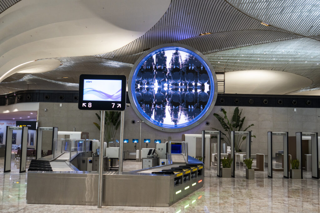 a large circular object with a screen on the wall